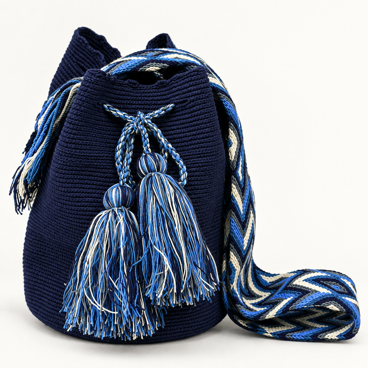 Bolso Wayuu azul marino tejido a mano en Colombia con borlas artesanales